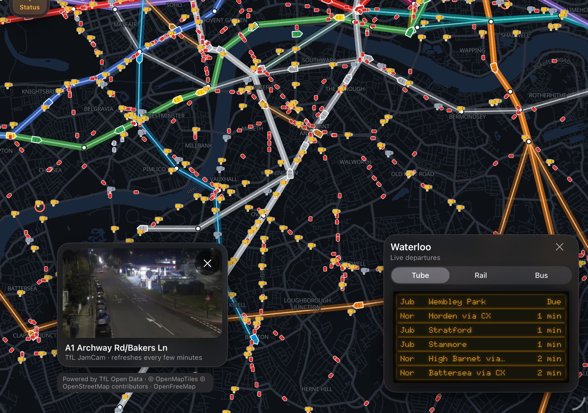 A live TfL JamCam traffic camera on the A1 Archway Road shown over the map, next to Waterloo's live Tube departures board